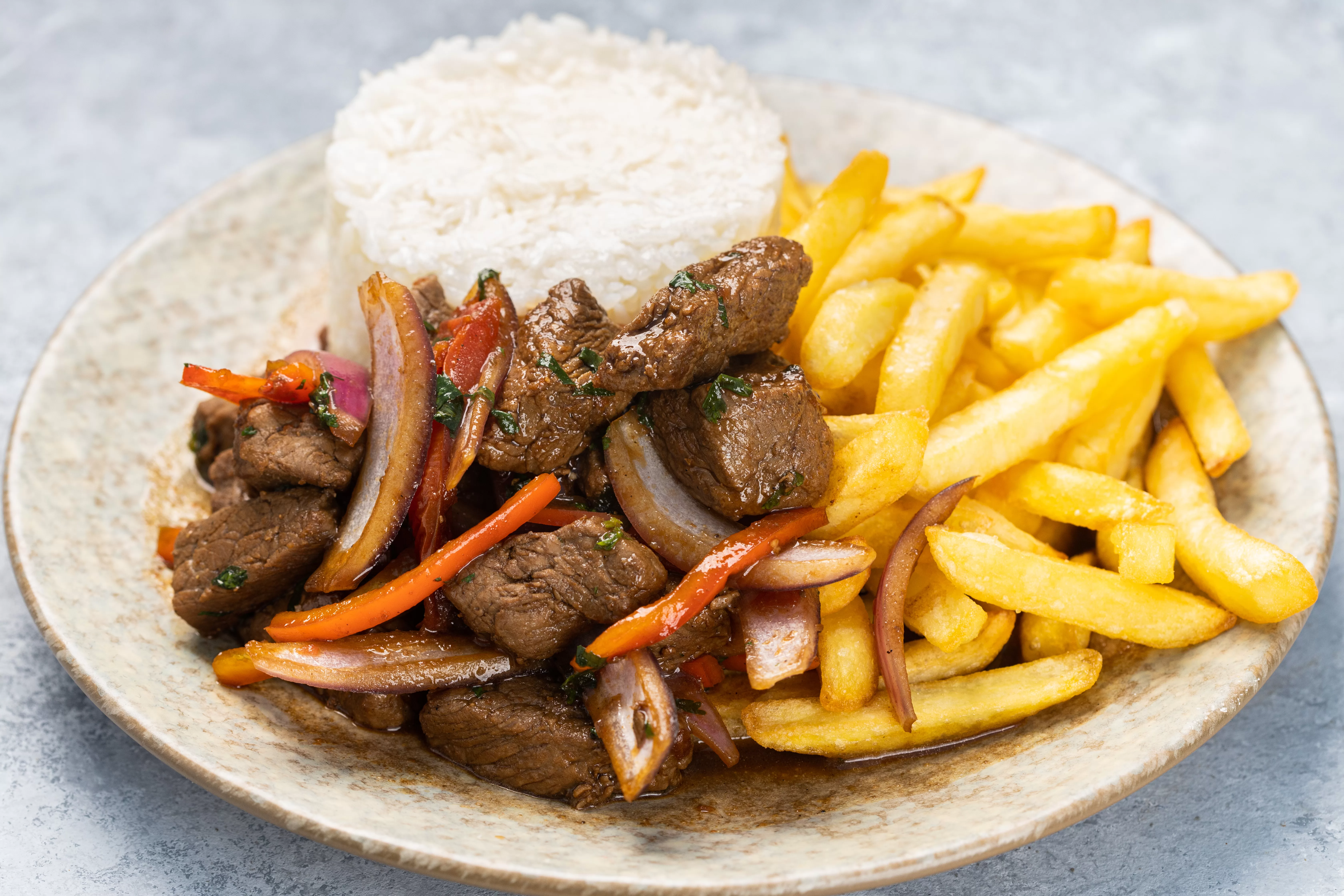 closeup-roasted-meat-with-sauce-vegetables-fries-plate-table.webp